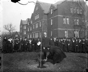 Milwaukee-Downer College graduates gather outside to plant a tree as part of the commencement ceremony in 1922 . 