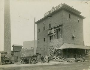 Photograph of a Cream City Mills building that was once located on N. Water Street. The Cream City Mill was also known as the Keenan Flour Mill, a company that first opened in the 1840s. 