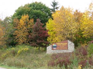 Photograph of the entry sign to Milwaukee's Havenwoods State Forest in autumn. 