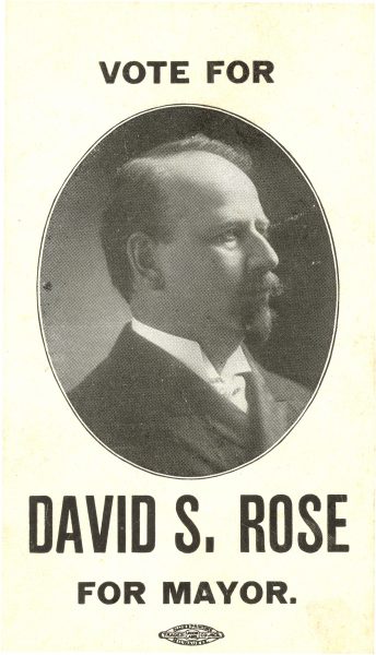 A campaign advertisement of David Rose showcases his headshot photograph. Rose, in formal attire, faces to the right. Text atop the photo reads "vote." The text beneath the image reads "David S. Rose For Mayor."