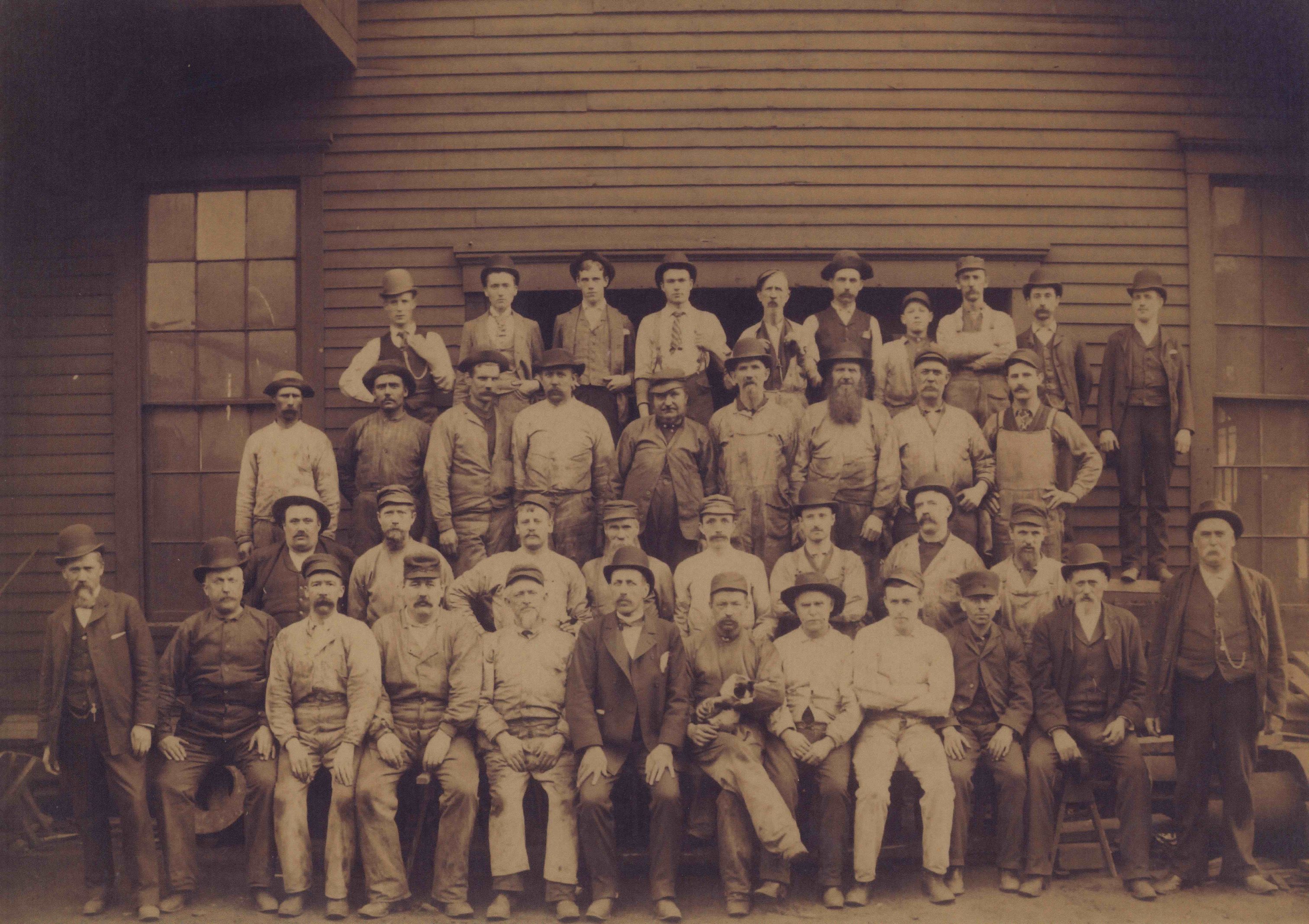 39 employees pose for a photograph at the Bay View Rolling Mill. This photo was taken in 1886, the year of the large and deadly workers' strike.