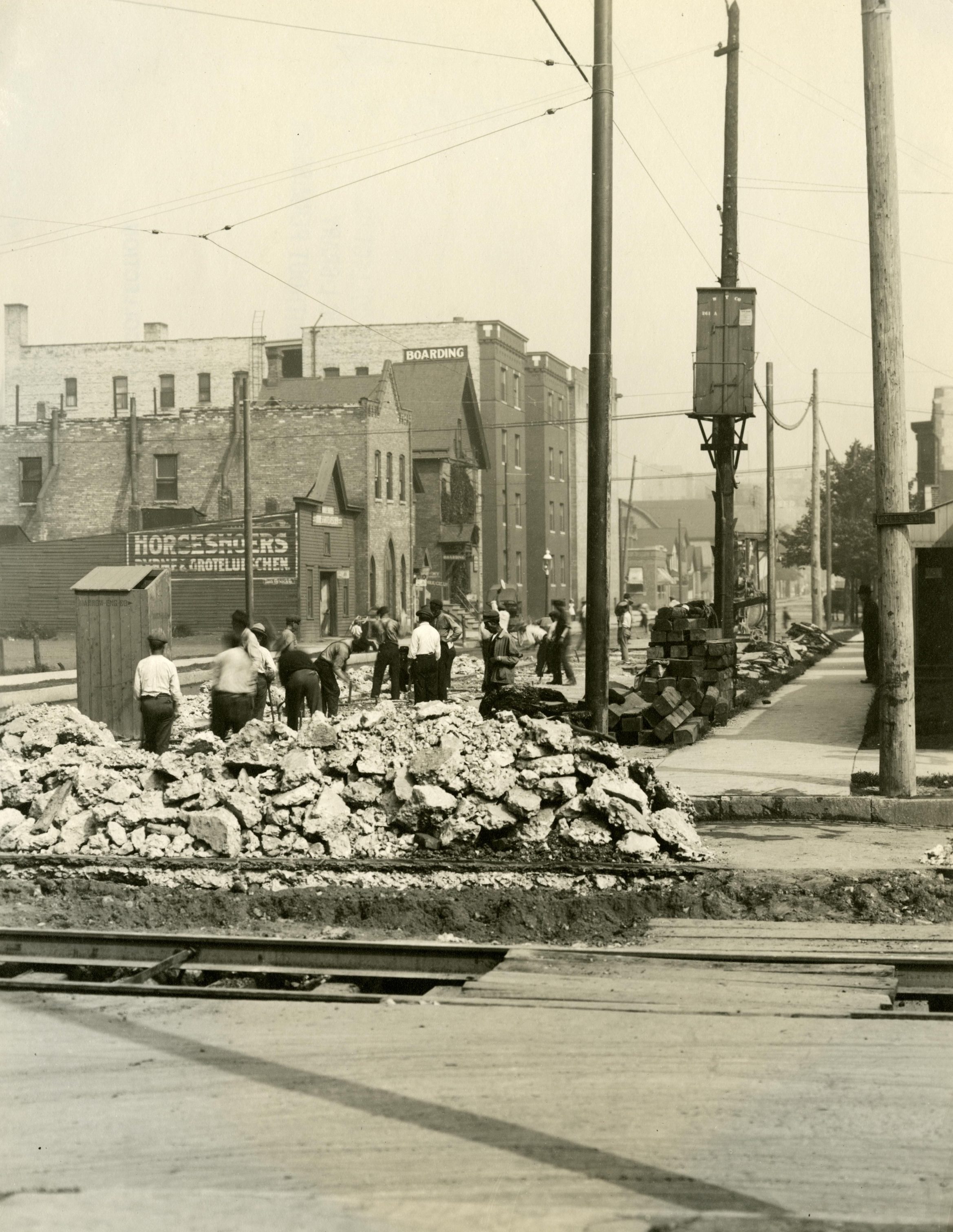 Men working on building the road at North 7th Street and West Wells in this 1913 photograph.
