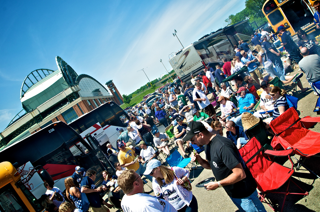 A crowd of people gather between buses to tailgate prior to a Brewer game in 2011.