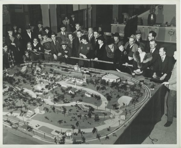 A crowd gathers around a large scale model railroad at the Wisconsin Hobby Exposition in Milwaukee in 1949.