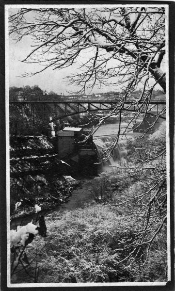 Photographs of watermills are rare because they were largely outmoded by the time photography became common. This undated photograph by Roman Kwasniewski shows a mill, bridge, and waterfall in winter.