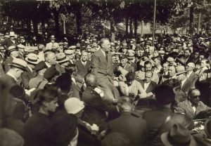 Photograph of President Franklin D. Roosevelt in the middle of a large crowd in 1932. 