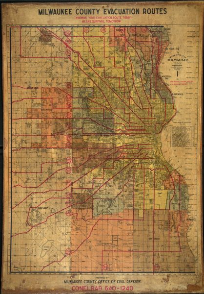 Red lines on map of Milwaukee County shows routes radiating from the downtown toward the peripheral areas. The pathways follow diagonals, straight, and zig zag directions. Each route is stamped with a combination number and letter code. Written as a subheading on top of the map is the slogan "Knowing Your Evacuation Route Today Means Survival Tomorrow."