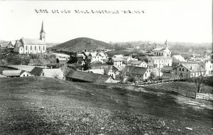This photo taken from atop a hill looks down towards Slinger in the early 20th century.