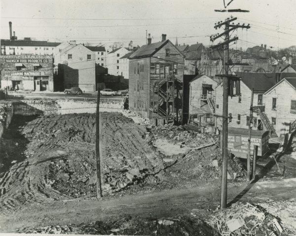Photograph of an demolished lot and other housing structures on W. Fond Du Lac Avenue that were eventually torn down and replaced by the Hillside Housing Development.