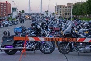 Rows of Harley Davidson motorcycles line a street as part of Harley's 115th anniversary celebration.