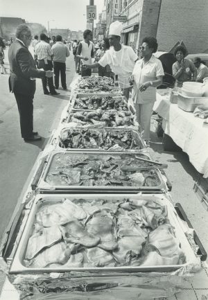 Attendees to Milwaukee's Juneteenth Day celebration in 1983 enjoy a variety of traditional African cuisines. Juneteenth Day, acknowledged as June 19, commemorates the emancipation of enslaved African-Americans in the former Confederate states.  