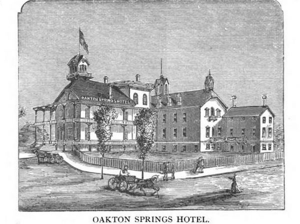 A sketch of the Oakton Springs Hotel in a frame. It shows the multiple-story adjoining buildings and their surrounding area. The facade stands on the farthest left back and faces slightly to the left. Numerous columns supported its first and second story. A tower sits atop the roof. Two sides of the tower are visible. A flag flaps above it. The hotel's name sign appears on the roof's side. The building's wing structures are situated next to the facade. A fence runs from the facade to the wings, leaving an empty bounded space between them. Some people walk the sidewalk that is built alongside the fence. Two trees and a horse-drawn vehicle appear on the street in the center foreground. Text at the bottom outside the frame reads "Oakton Spring Hotel."