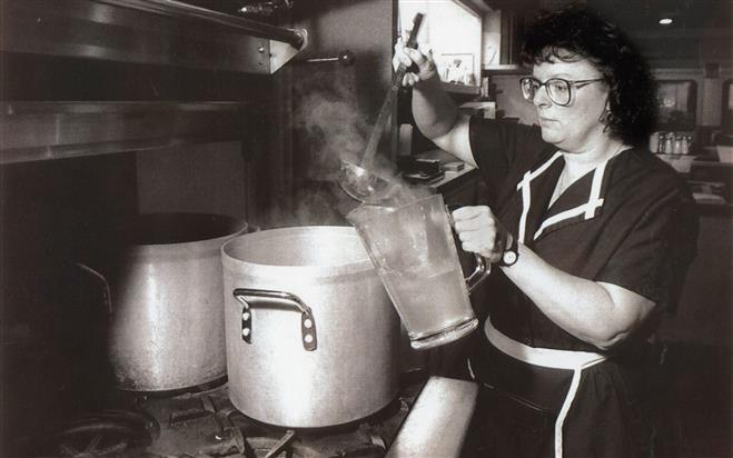Barbara Franke, a waitress at Miss Katie's Diner in Milwaukee, pours boiled water into a pitcher for customers. 