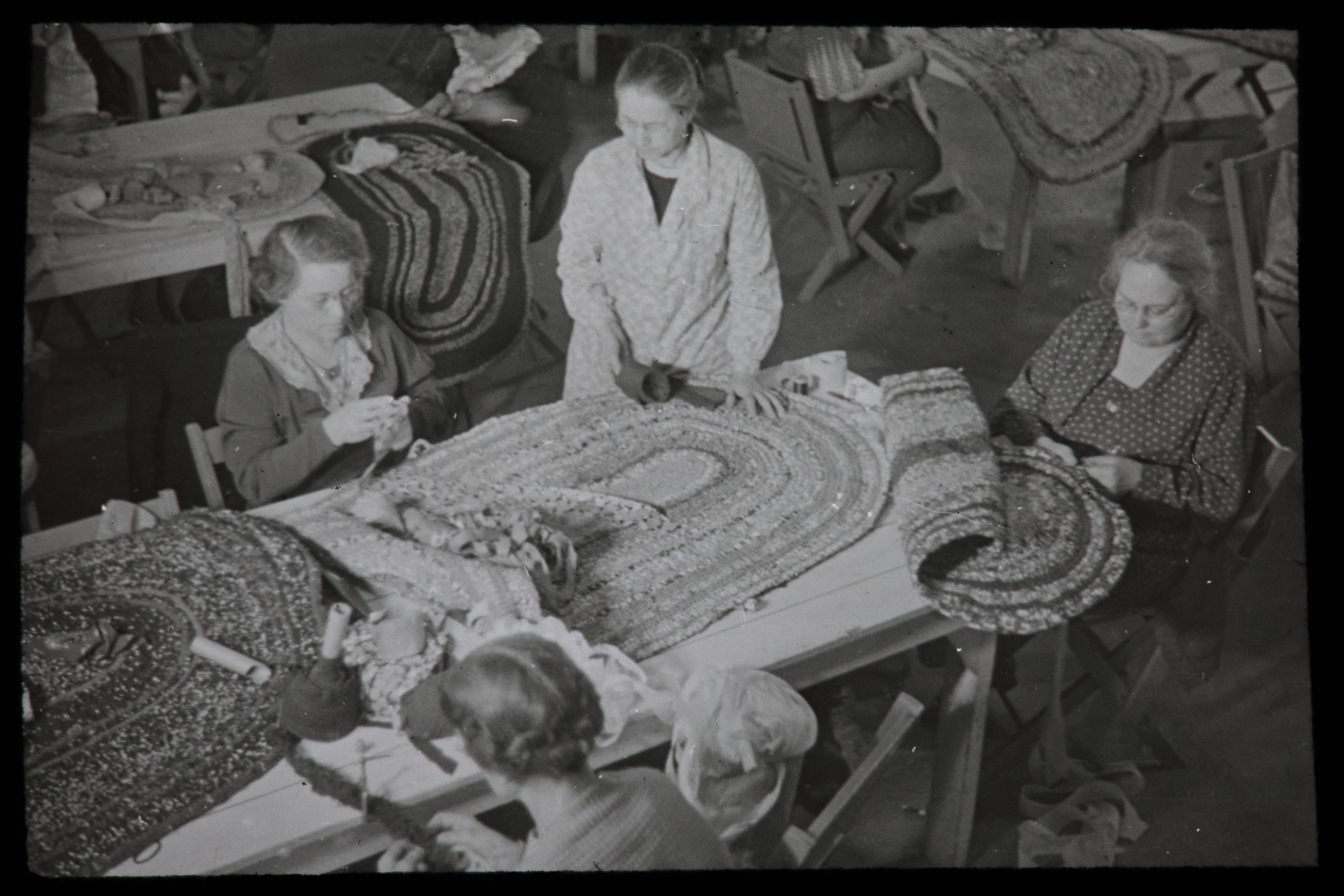 Four women work to make crochet rugs as part of the Milwaukee Handicraft Project. Begun in 1935, the project was designed to provide women with employment during the Great Depression.