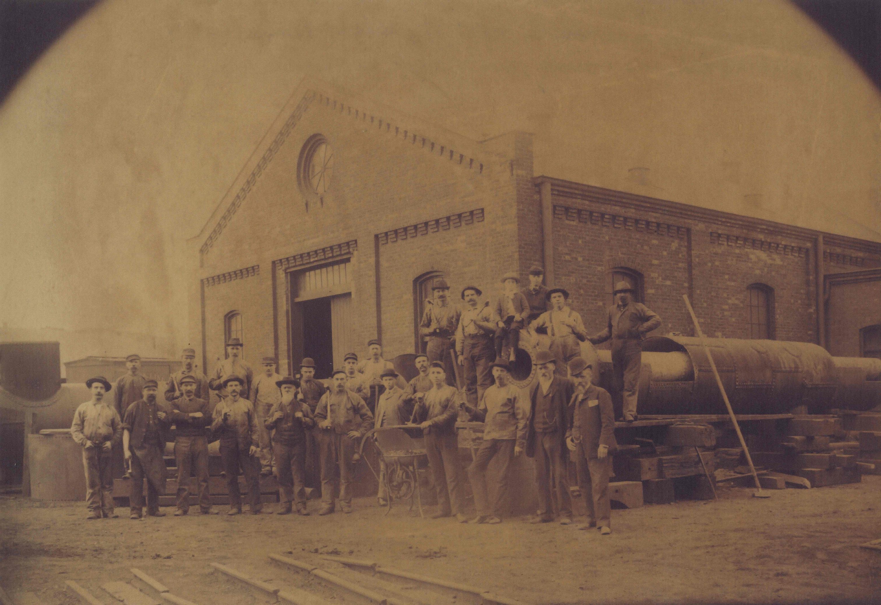 Illinois Steel employees stand in front of the rolling mill in Bay View in 1886. That same year, the mill was the site of strike spurred by the Eight-Hour Movement.