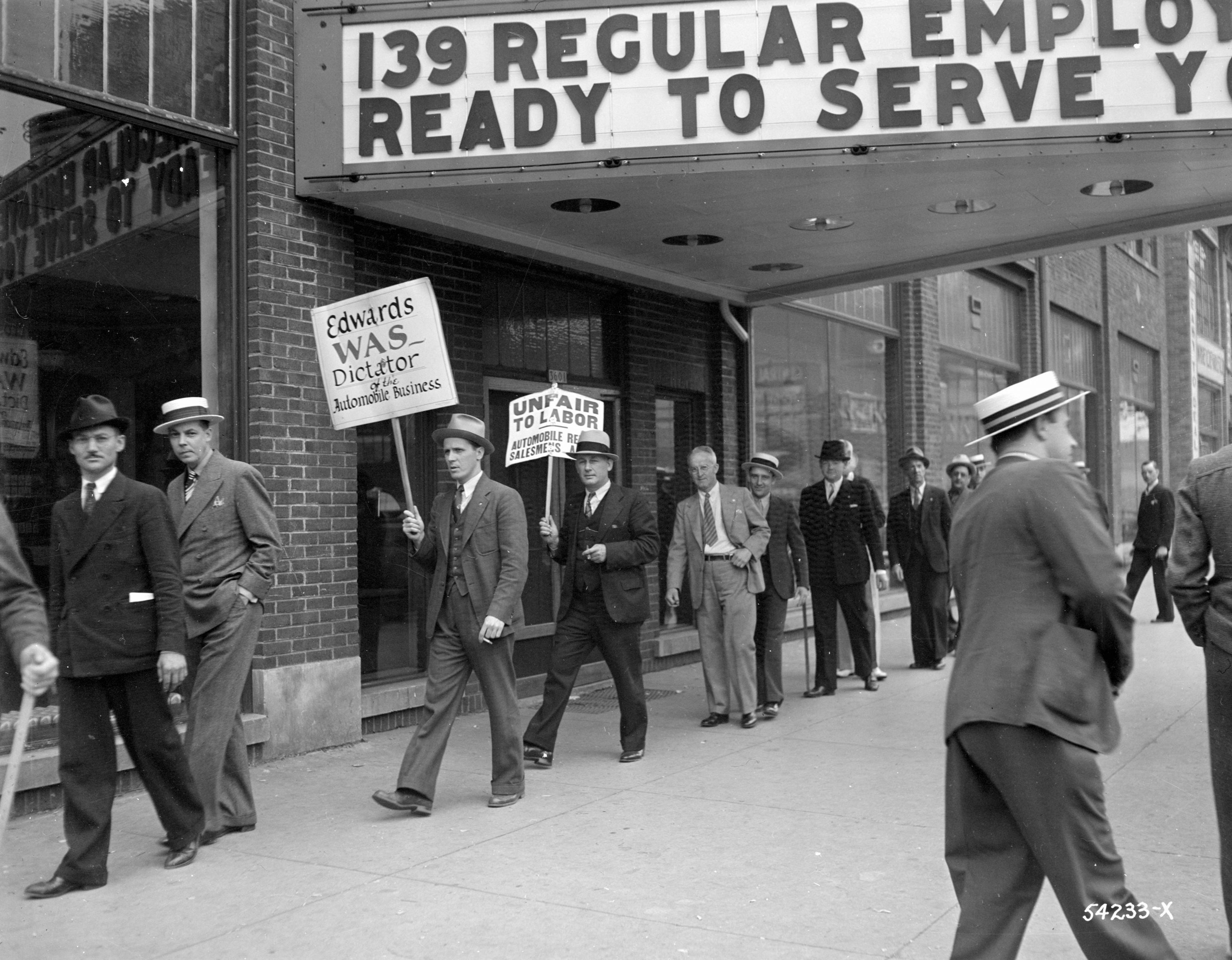 A group of workers from the Edwards Motor Company picket with strike signs on Wisconsin Avenue in 1937.