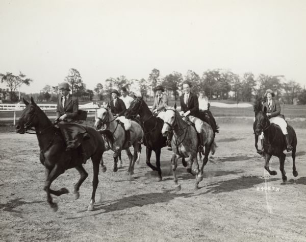 A group of young people ride horses at the Milwaukee Hunt Club in River Hills in 1930 with a golf course in the background. The country club was the center of community life for the village's wealthy residents.