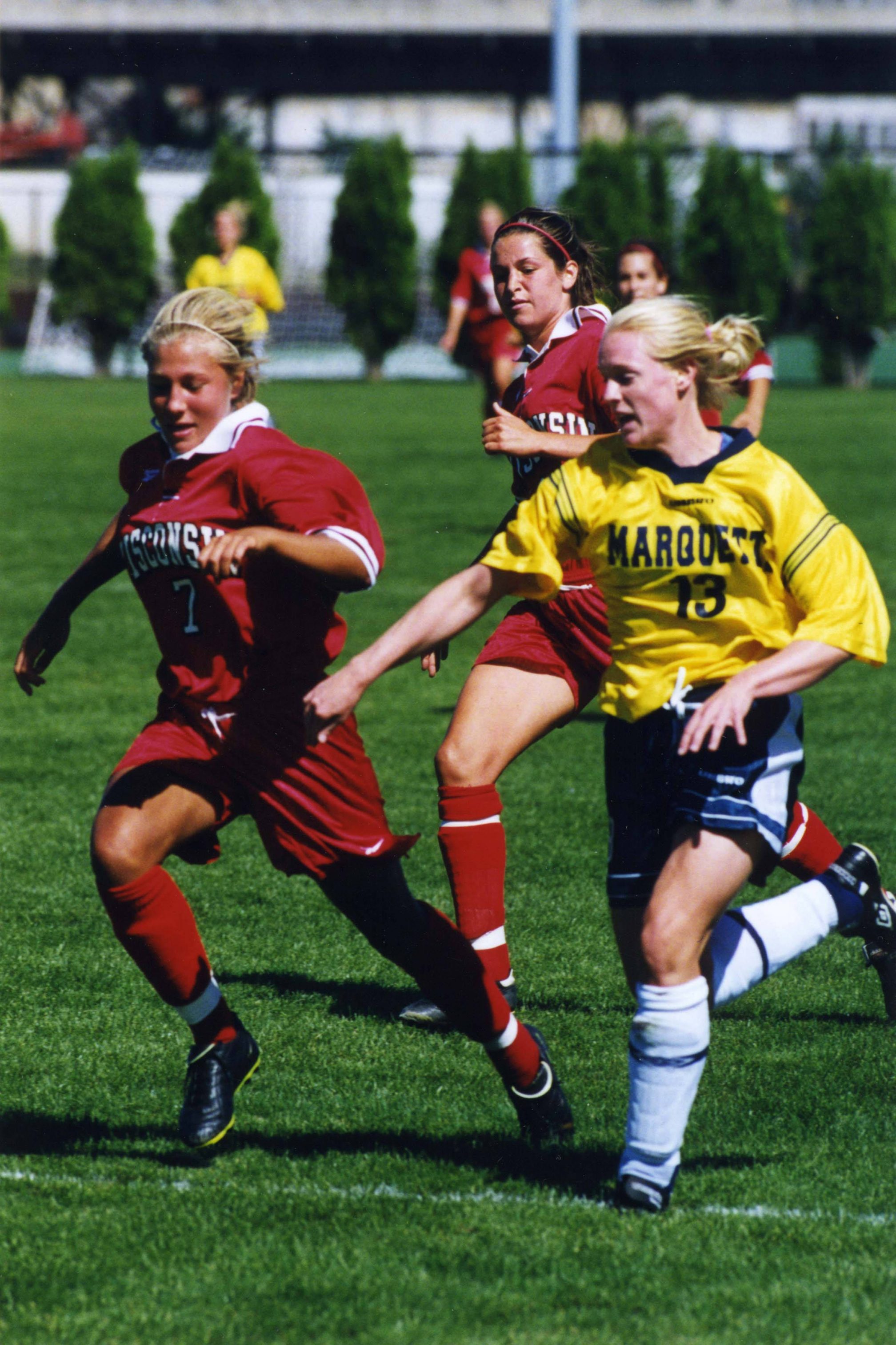 Kate Gordon of Marquette University's women's soccer team tries to outrun her opponent from the University of Wisconsin in 1999. 