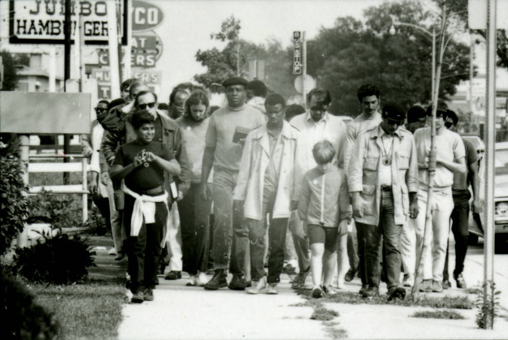A group of protestors, led by Father James Groppi, participate in a welfare march from Milwaukee to Madison in 1969.