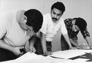 Roberto Hernandez (left), along with Esequiel Guzman (center) and another man work to set the layout of an issue of the "La Guardia" newspaper. 