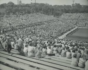 A large crowd of people fills bleachers to celebrate Milwaukee's 100th birthday. Centurama activities lasted an entire month. 