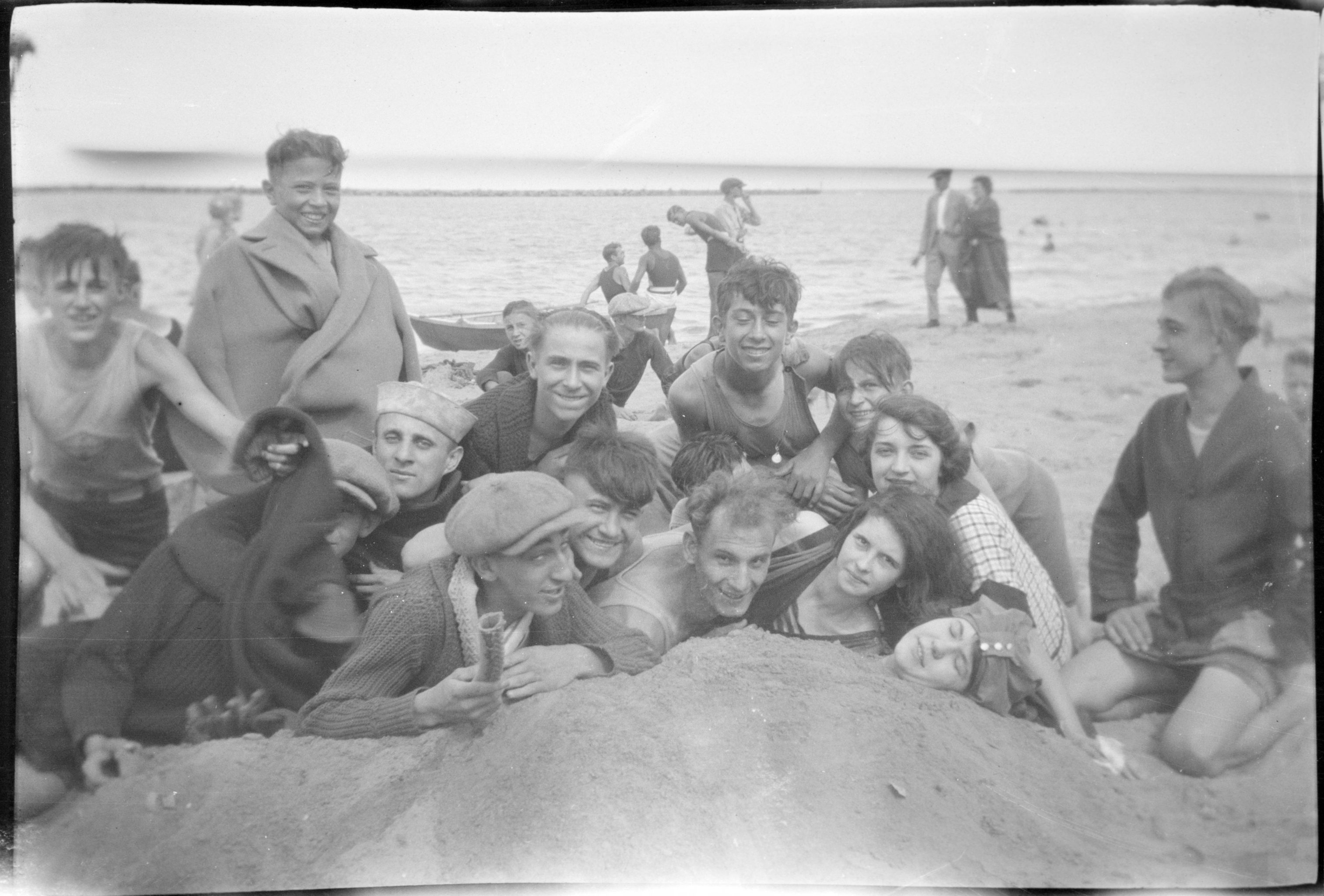 A group of young men and women enjoy a day at the beach during the first half of the twentieth century. 