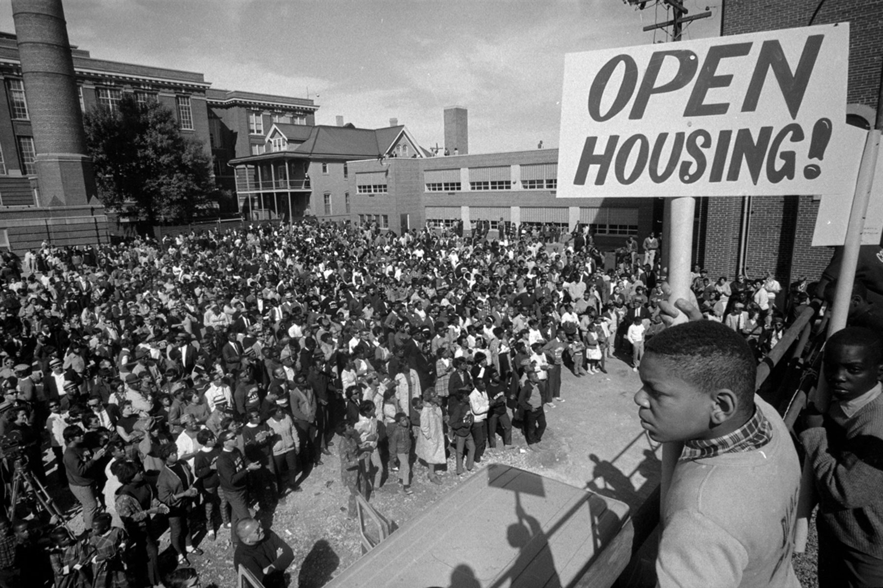 The Milwaukee Metropolitan Fair Housing Council was born out of the Civil Rights Movement and open housing demonstrations of the 1960s. A large group of such demonstrators are pictured here outside St. Boniface Church.  